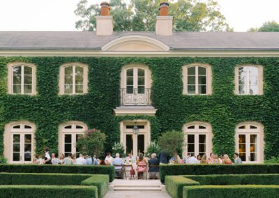 A wedding reception at a mansion with ivy covered walls.